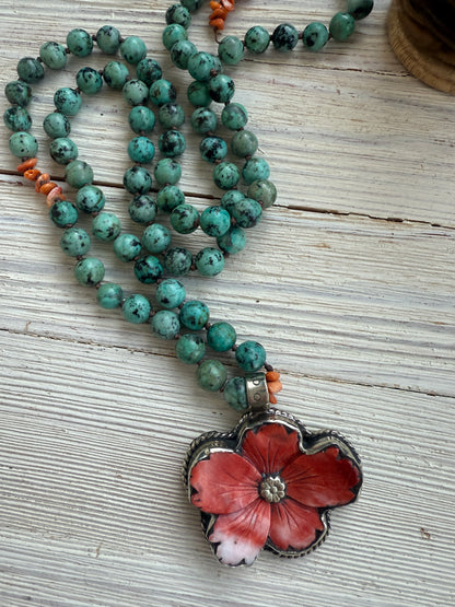 Spiny oyster flower pendant from Tibet on knotted turquoise with spiny oyster accents. 34” long necklace.