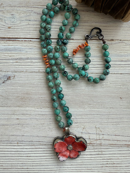 Spiny oyster flower pendant from Tibet on knotted turquoise with spiny oyster accents. 34” long necklace.