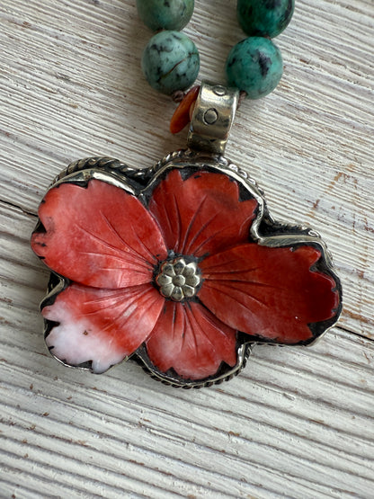 Spiny oyster flower pendant from Tibet on knotted turquoise with spiny oyster accents. 34” long necklace.