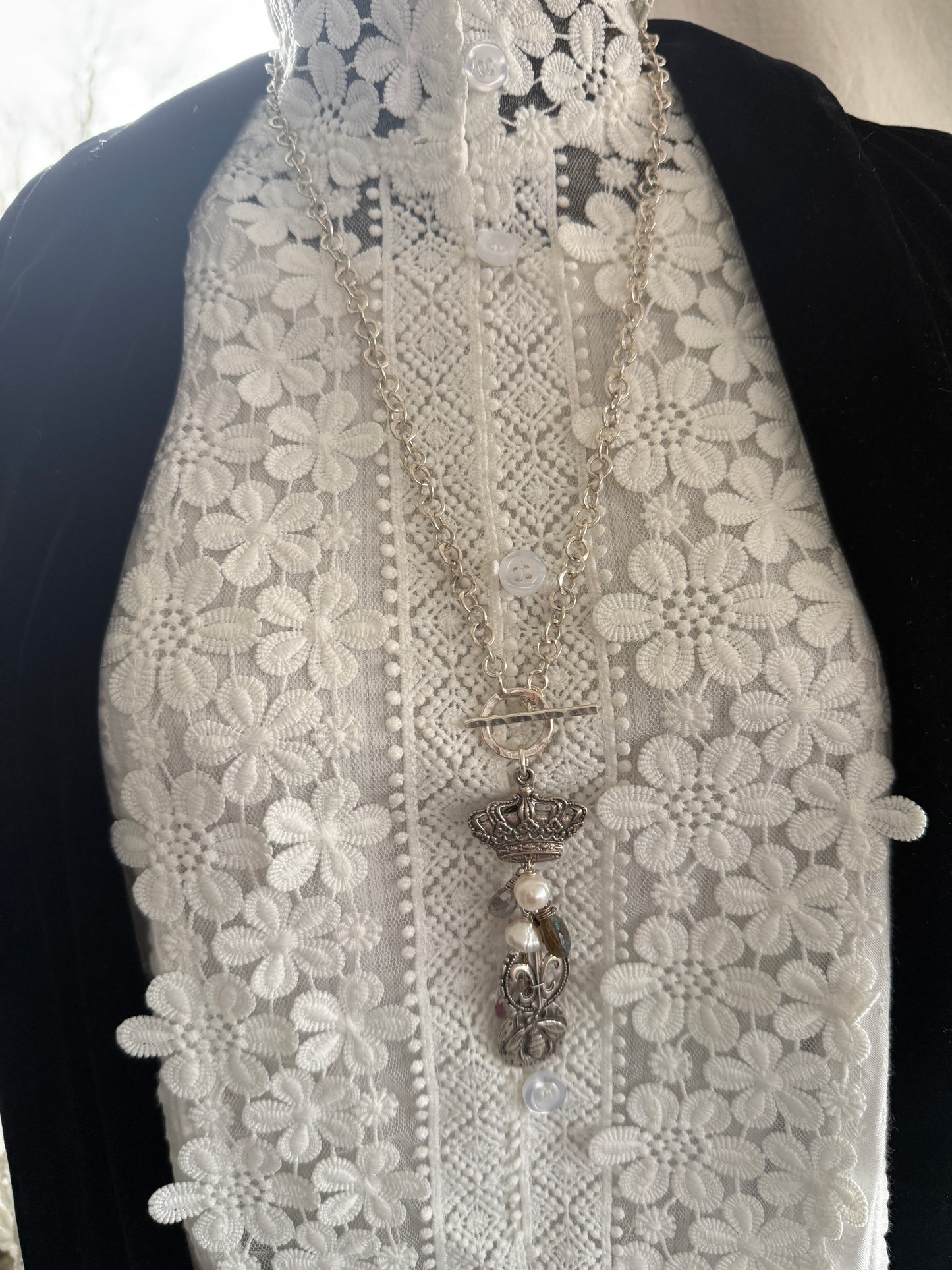 Sterling silver crown, fleur de lis, and bee charms on long fine silver chain. 25.5”