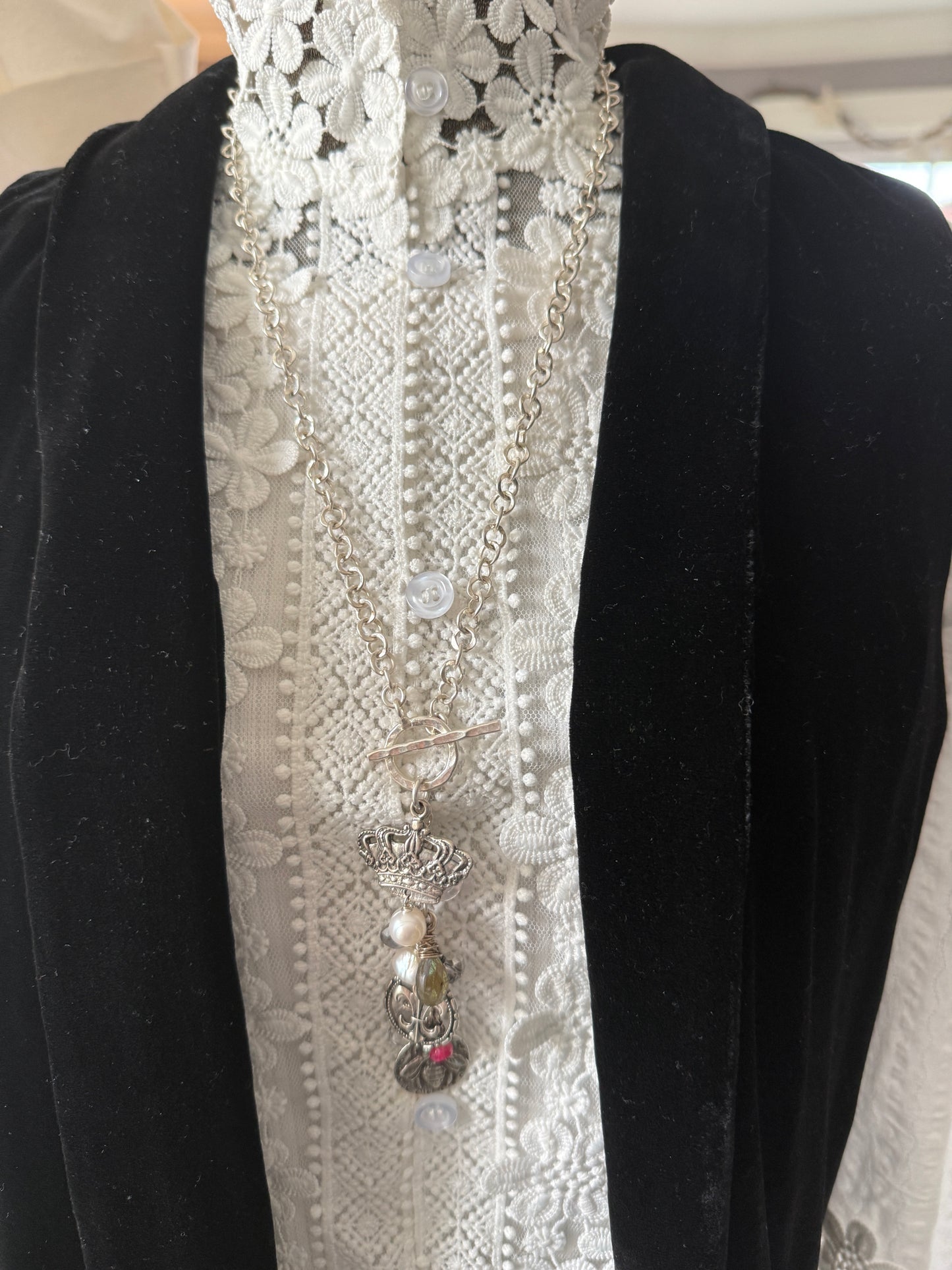 Sterling silver crown, fleur de lis, and bee charms on long fine silver chain. 25.5”