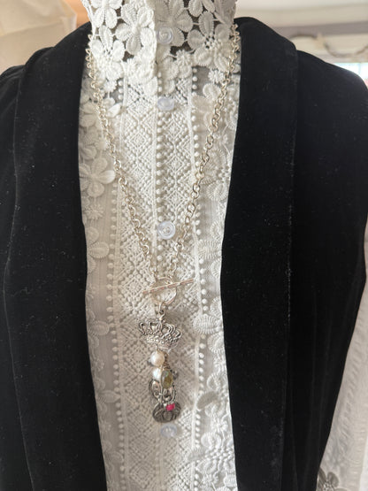 Sterling silver crown, fleur de lis, and bee charms on long fine silver chain. 25.5”