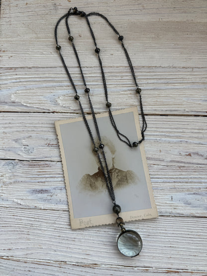 Antiqued bronze locket on sterling silver and pyrite chain. 32” necklace.