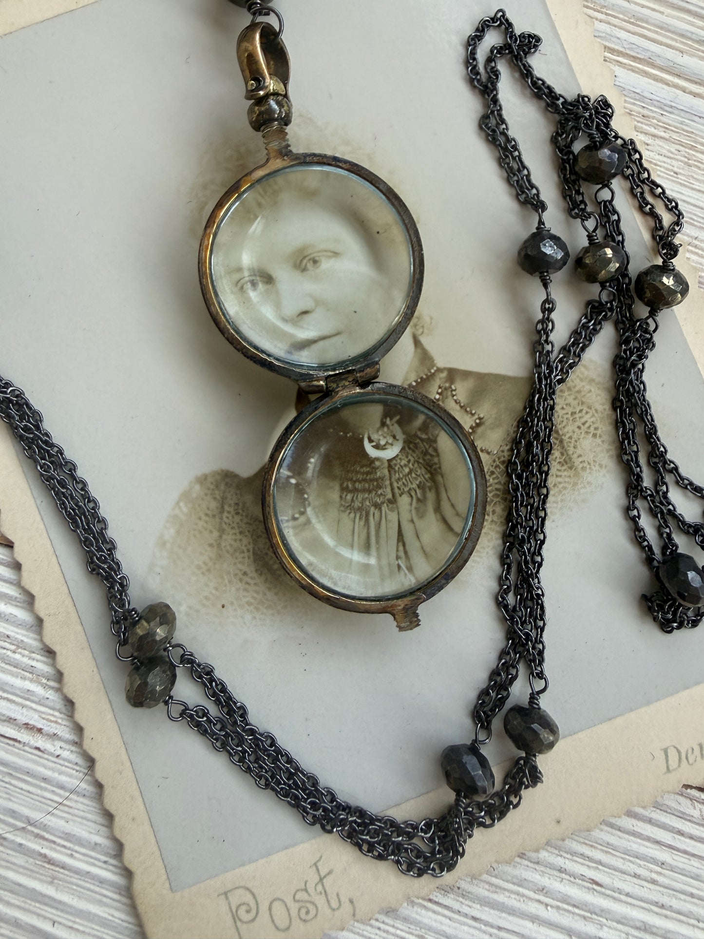 Antiqued bronze locket on sterling silver and pyrite chain. 32” necklace.