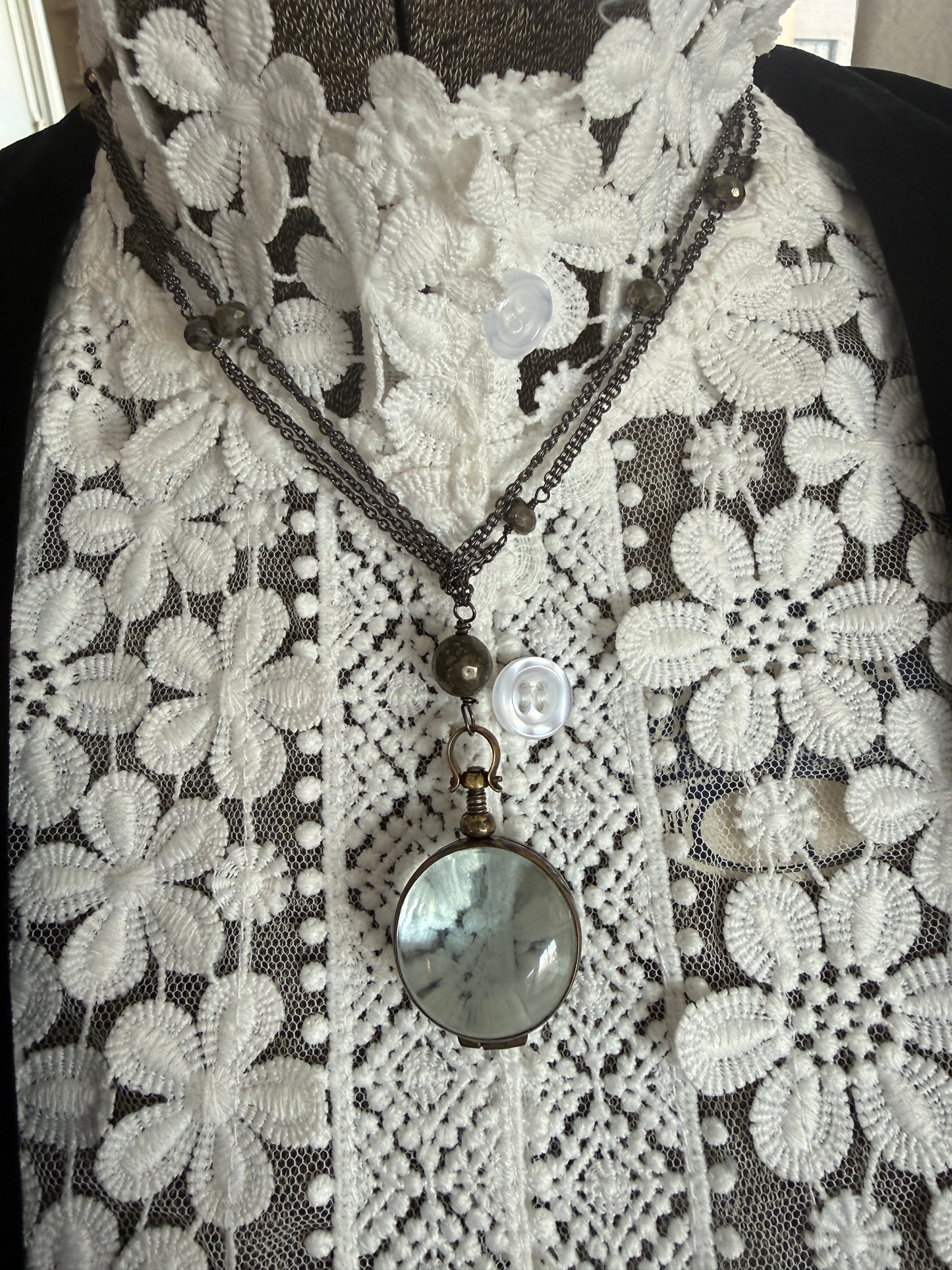 Antiqued bronze locket on sterling silver and pyrite chain. 32” necklace.