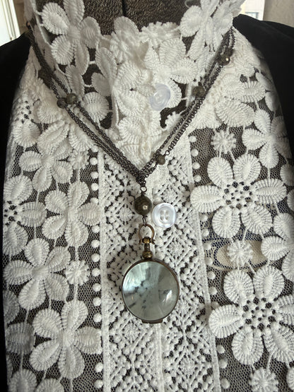 Antiqued bronze locket on sterling silver and pyrite chain. 32” necklace.
