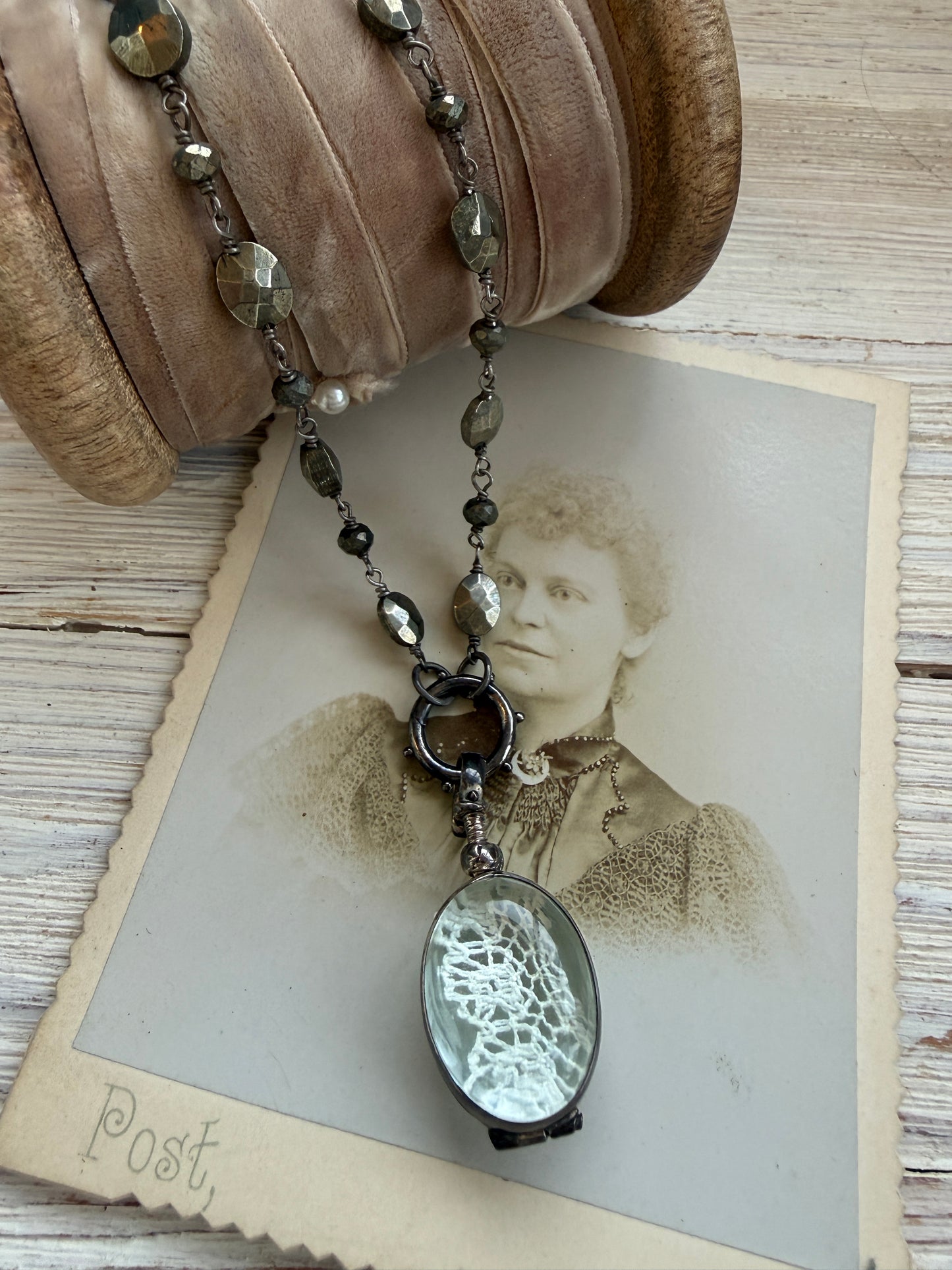Antiqued sterling locket on faceted pyrite chain. 34” long necklace.