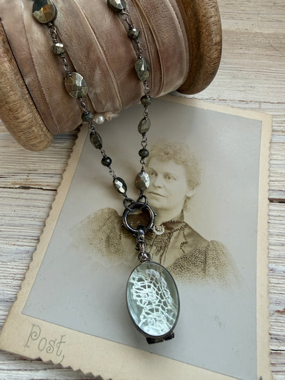 Antiqued sterling locket on faceted pyrite chain. 34” long necklace.