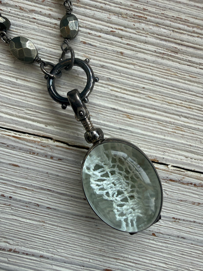 Antiqued sterling locket on faceted pyrite chain. 34” long necklace.