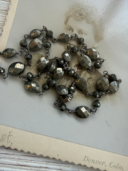 Antiqued sterling locket on faceted pyrite chain. 34” long necklace.