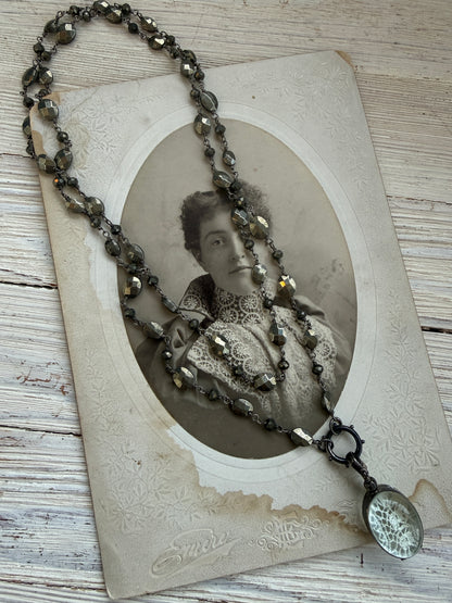 Antiqued sterling locket on faceted pyrite chain. 34” long necklace.