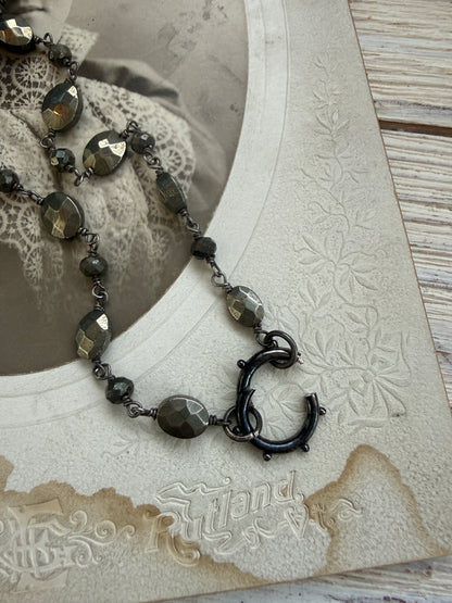 Antiqued sterling locket on faceted pyrite chain. 34” long necklace.
