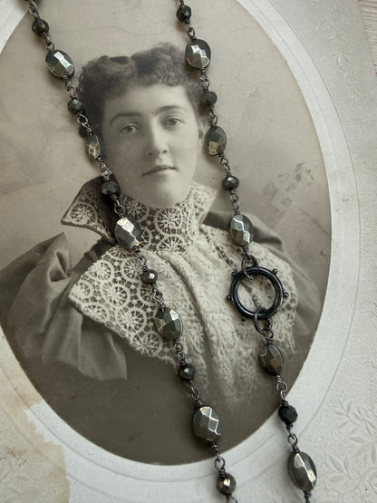 Antiqued sterling locket on faceted pyrite chain. 34” long necklace.