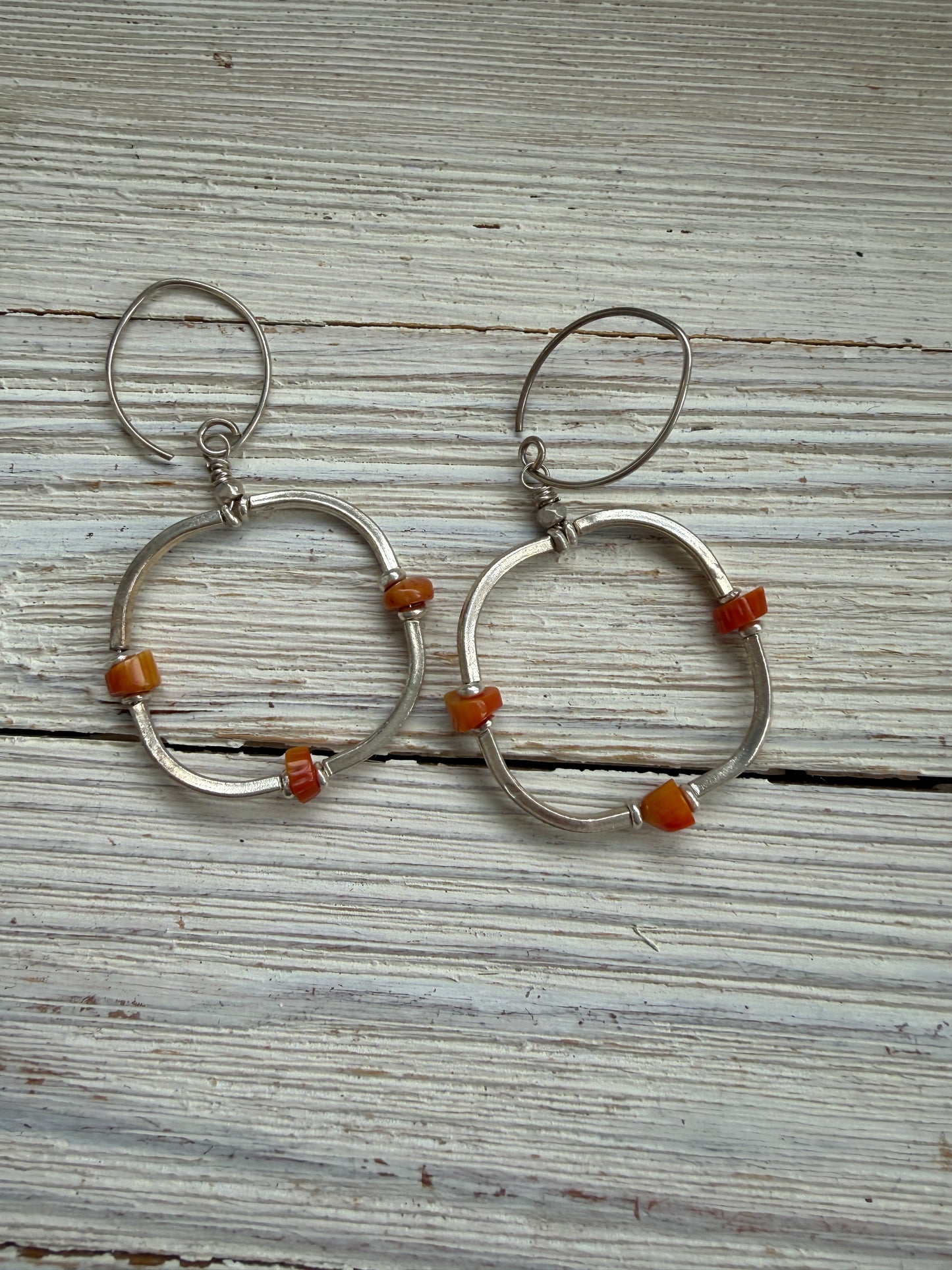 Segmented hoops of fine silver with broom coral accents earrings.