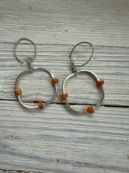 Segmented hoops of fine silver with broom coral accents earrings.