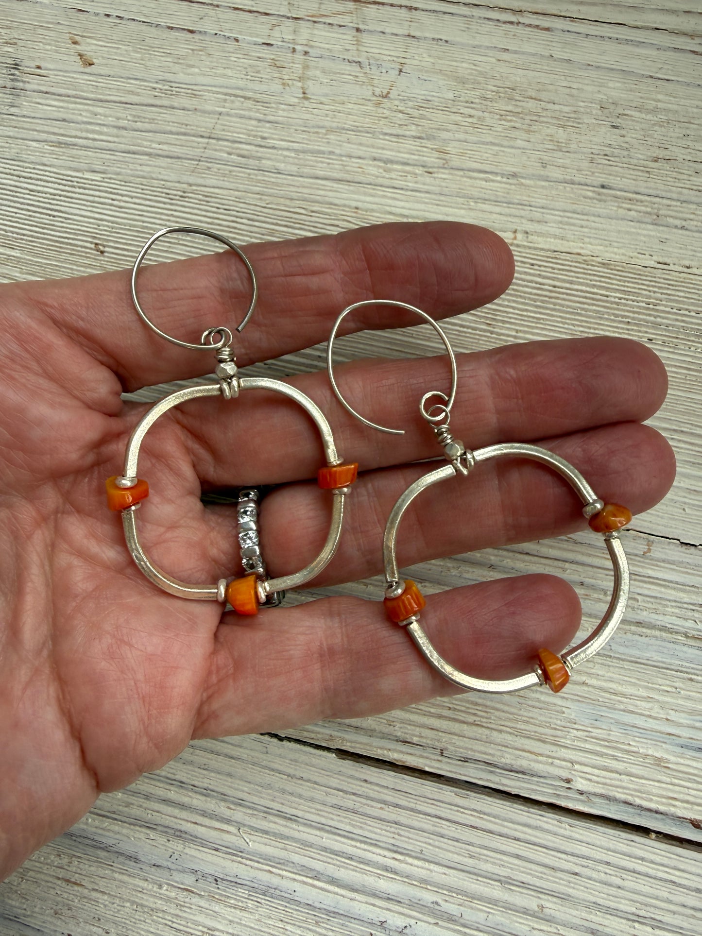 Segmented hoops of fine silver with broom coral accents earrings.
