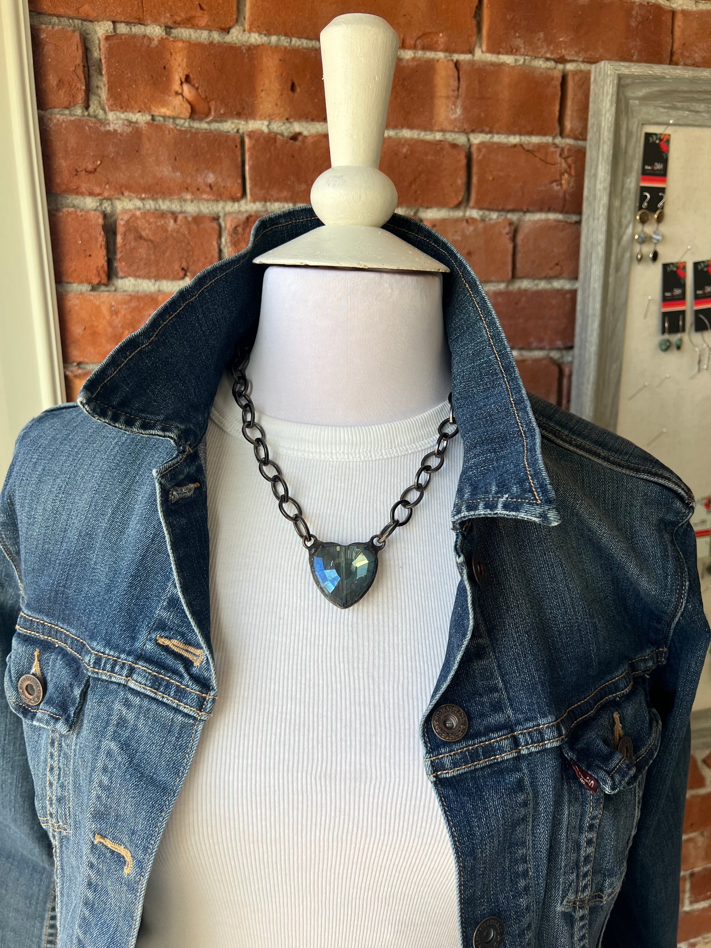 Faceted, blue glass heart on gunmetal chain necklace.