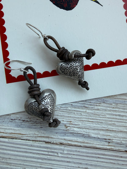 Stamped fine silver hearts on leather earrings.