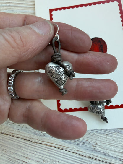 Stamped fine silver hearts on leather earrings.