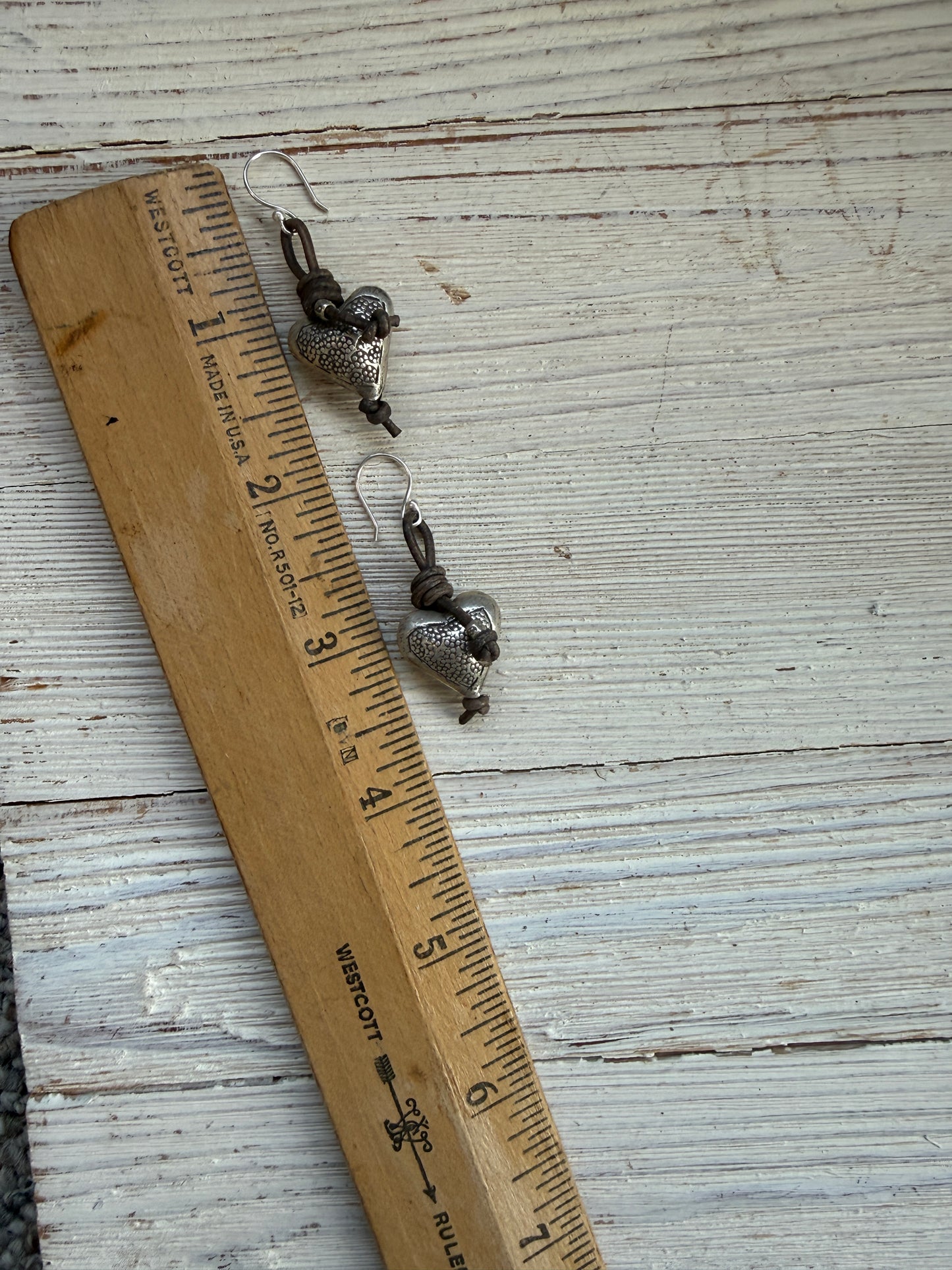 Stamped fine silver hearts on leather earrings.