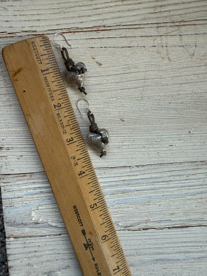 Stamped fine silver hearts on leather earrings.