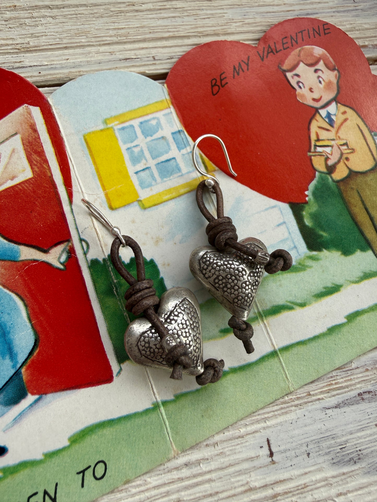 Stamped fine silver hearts on leather earrings.