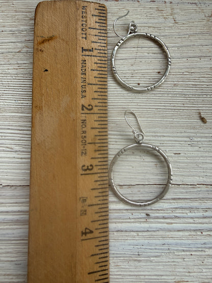Stamped fine silver hoop earrings.