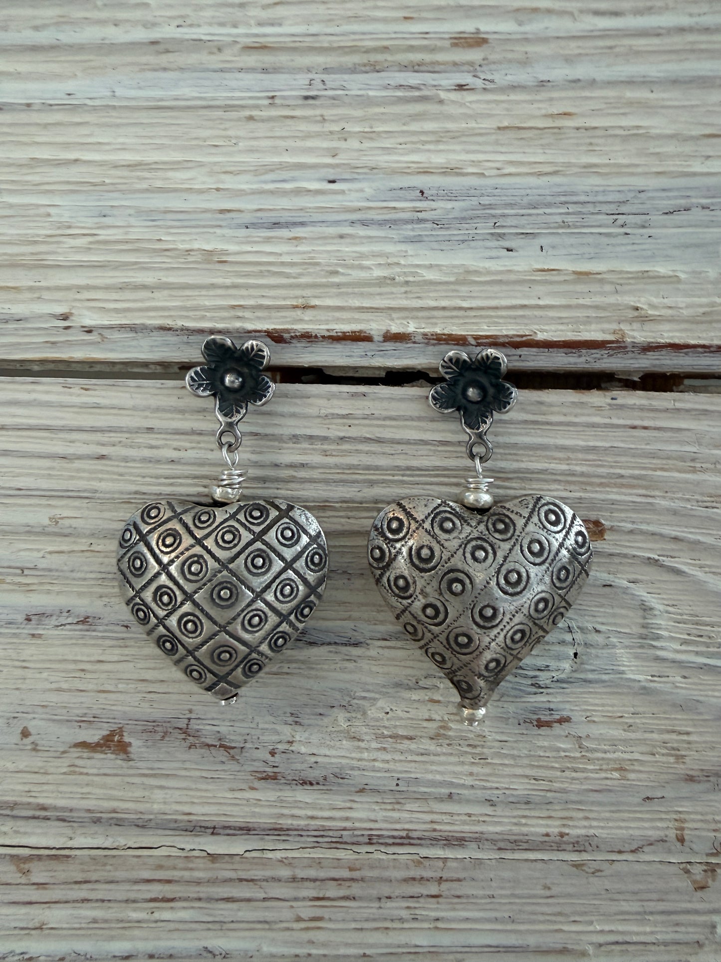 Fine silver puffy hearts on flower post earrings.