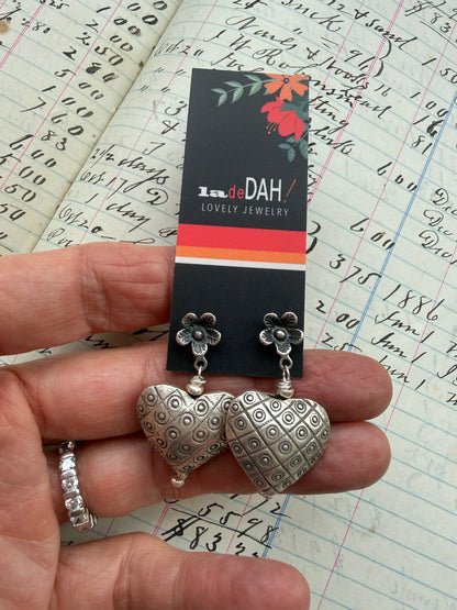 Fine silver puffy hearts on flower post earrings.