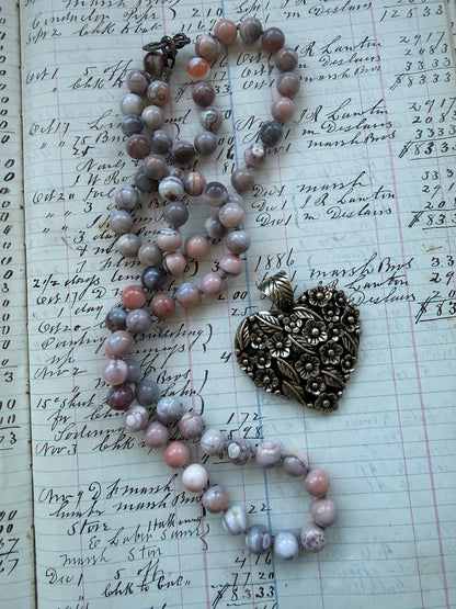 Tibetan flowered heart pendant on pink Botswana agates long necklace.