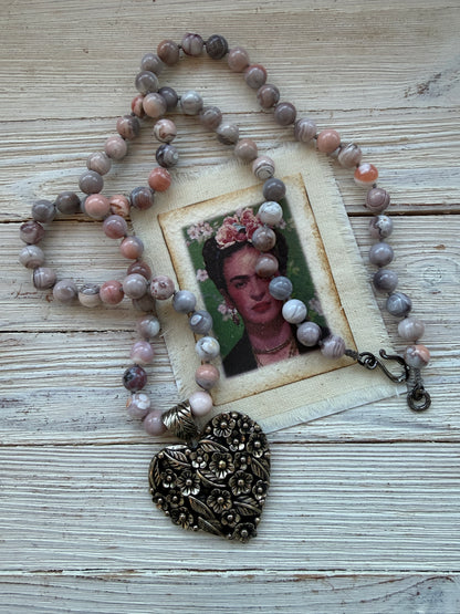 Tibetan flowered heart pendant on pink Botswana agates long necklace.