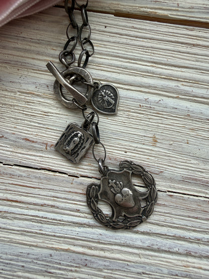 Oxidized sterling silver chain with sterling silver religious medals and fine silver front toggle necklace.