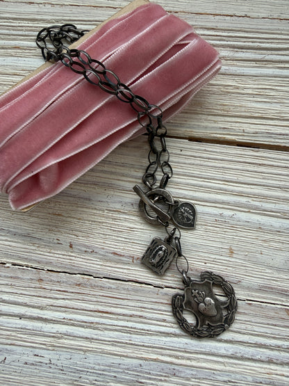 Oxidized sterling silver chain with sterling silver religious medals and fine silver front toggle necklace.