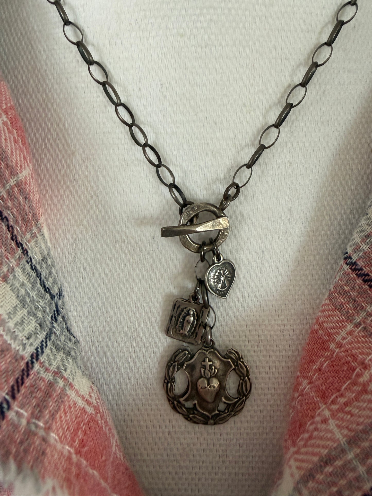 Oxidized sterling silver chain with sterling silver religious medals and fine silver front toggle necklace.