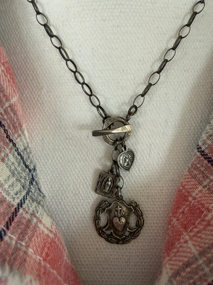 Oxidized sterling silver chain with sterling silver religious medals and fine silver front toggle necklace.