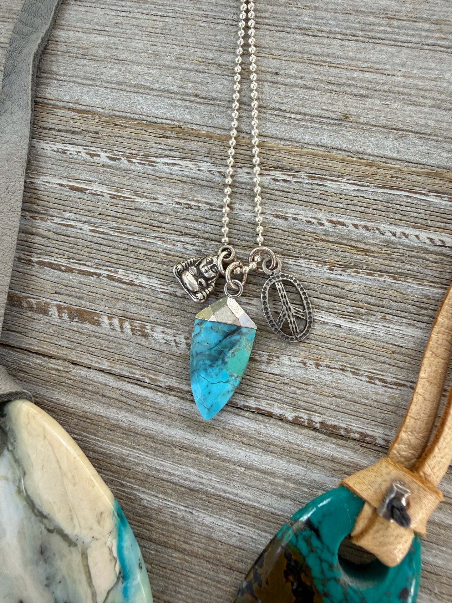 Turquoise spear with sterling Buddha and peace charms on sterling ball chain necklace. 18”