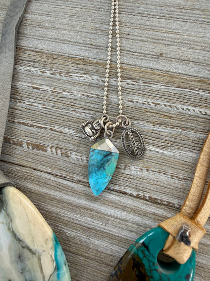 Turquoise spear with sterling Buddha and peace charms on sterling ball chain necklace. 18”