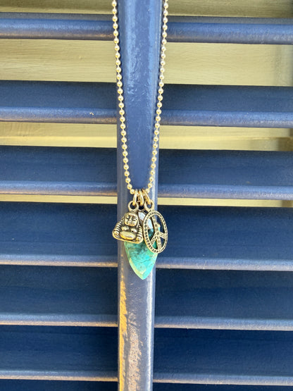 Turquoise spear with sterling Buddha and peace charms on sterling ball chain necklace. 18”