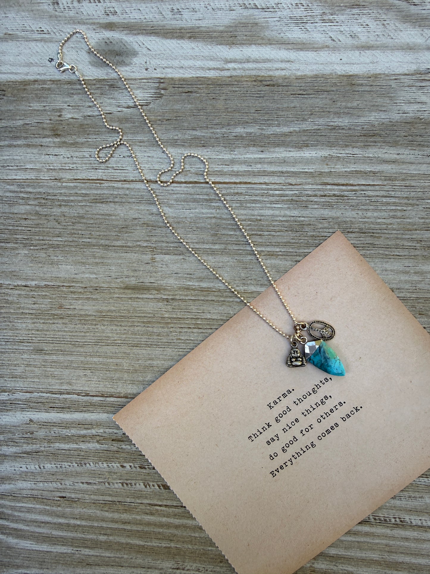 Turquoise spear with sterling Buddha and peace charms on sterling ball chain necklace. 18”
