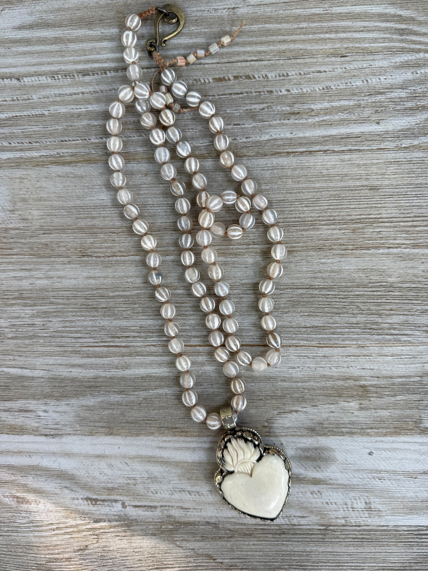 Knotted white striped agate Dzi beads long necklace with removable carved bone Tibetan flaming heart pendant. 35”