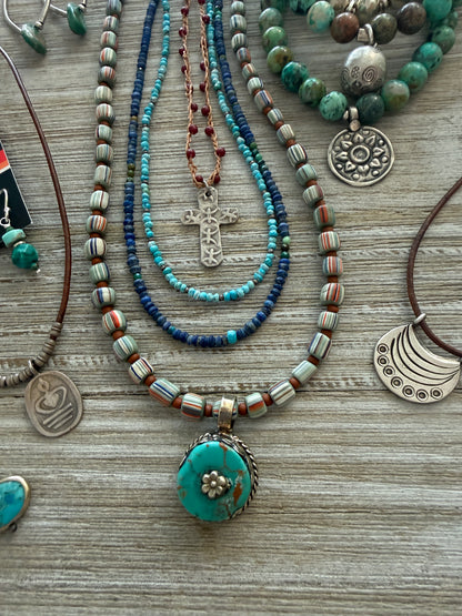 Tibetan turquoise pendant on striped Java beads. Fine silver hook clasp. 21”.