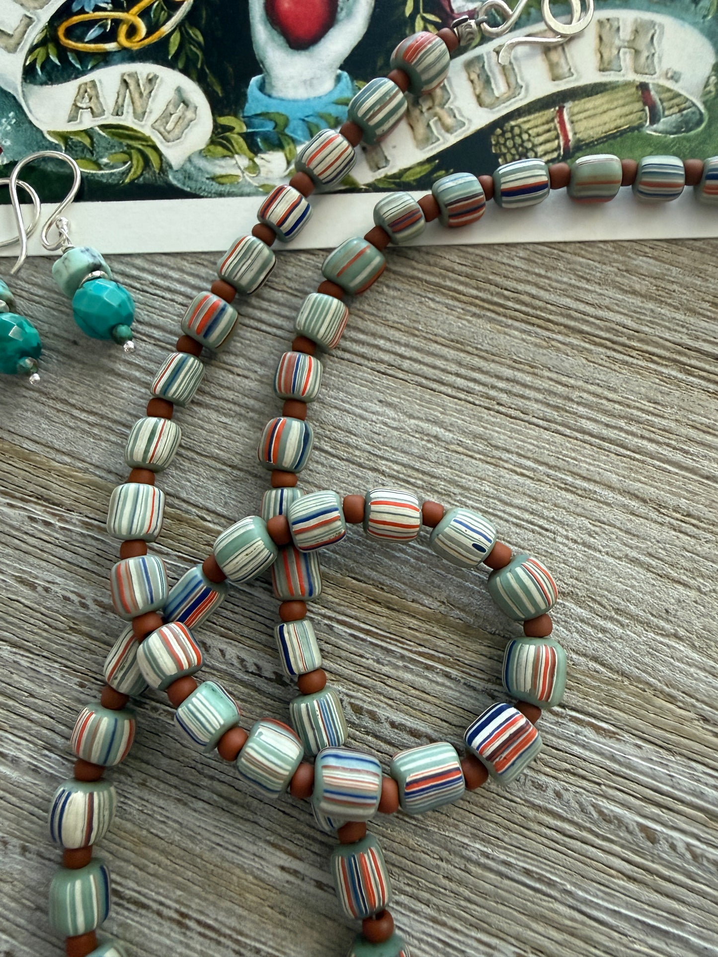 Tibetan turquoise pendant on striped Java beads. Fine silver hook clasp. 21”.