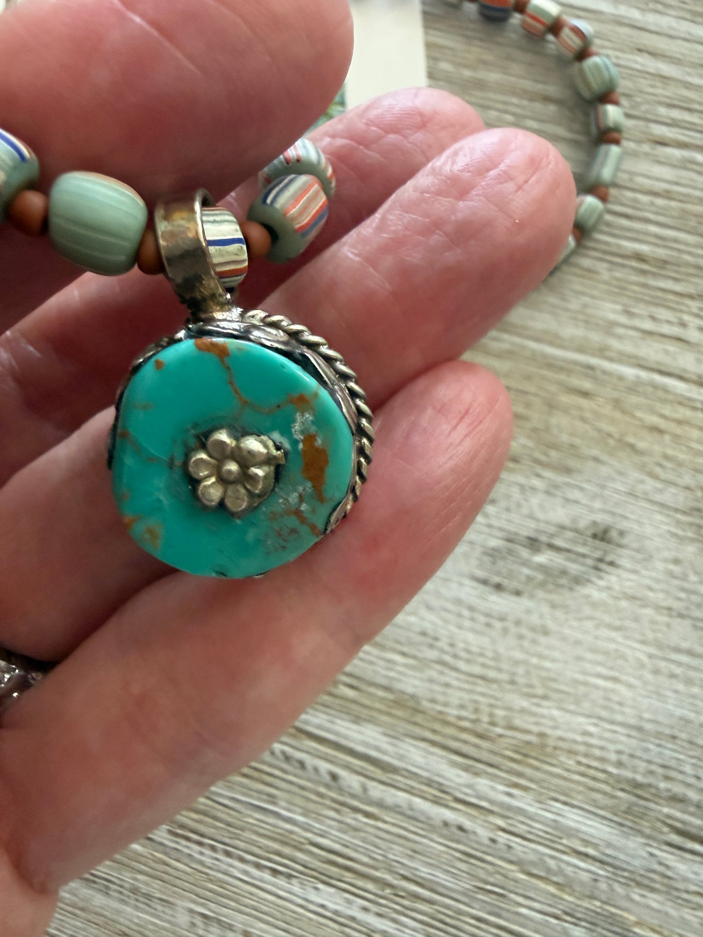 Tibetan turquoise pendant on striped Java beads. Fine silver hook clasp. 21”.