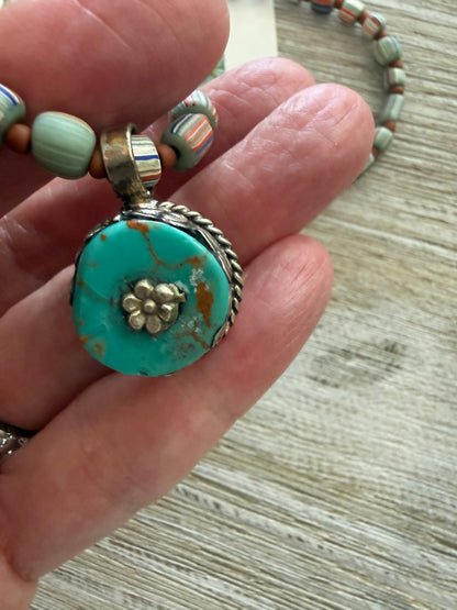 Tibetan turquoise pendant on striped Java beads. Fine silver hook clasp. 21”.