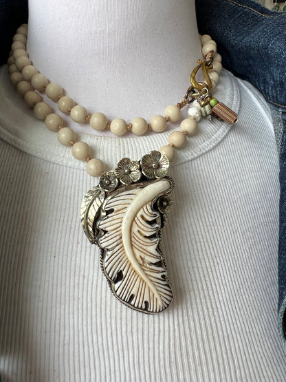 Bone feather on riverstone long boho necklace.