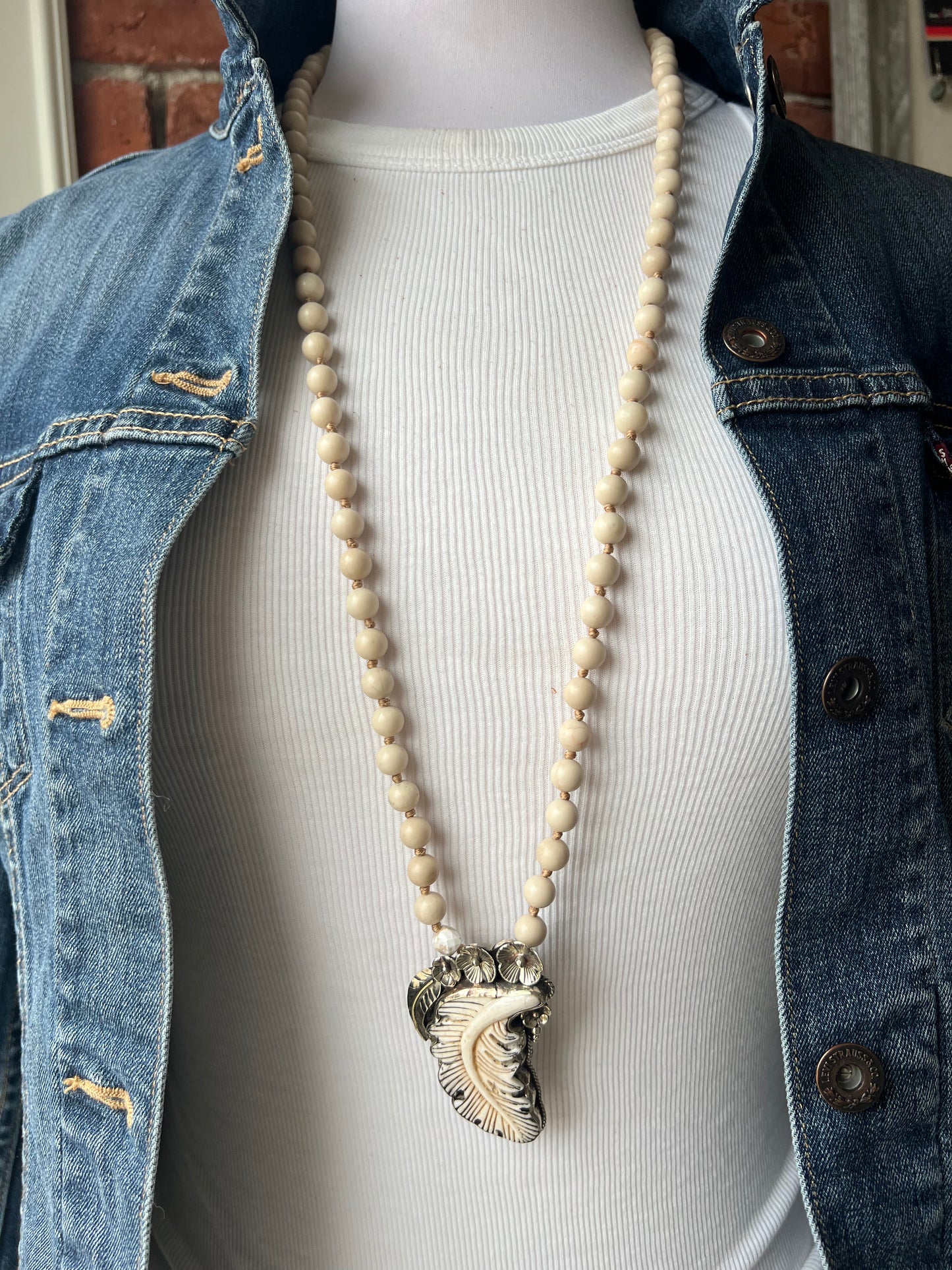 Bone feather on riverstone long boho necklace.