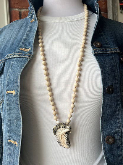 Bone feather on riverstone long boho necklace.