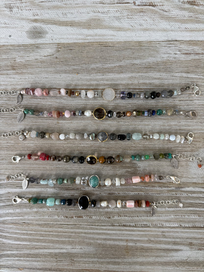 Assorted gemstones with smoky quartz focal bracelet. Sterling clasp and extender chain. 7-8.25”