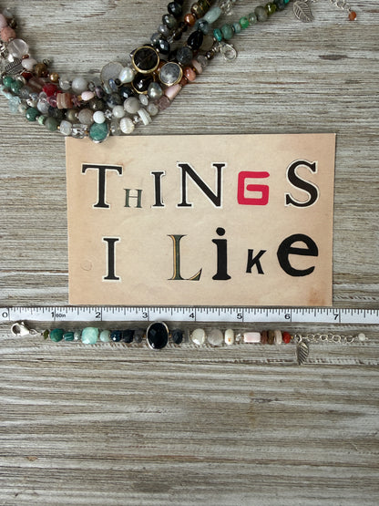 Mixed gemstone bracelet with black onyx focal bead and sterling clasp and extender chain. 6-7”