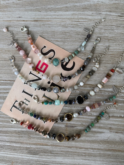Mixed gemstone bracelet with black onyx focal bead and sterling clasp and extender chain. 6-7”